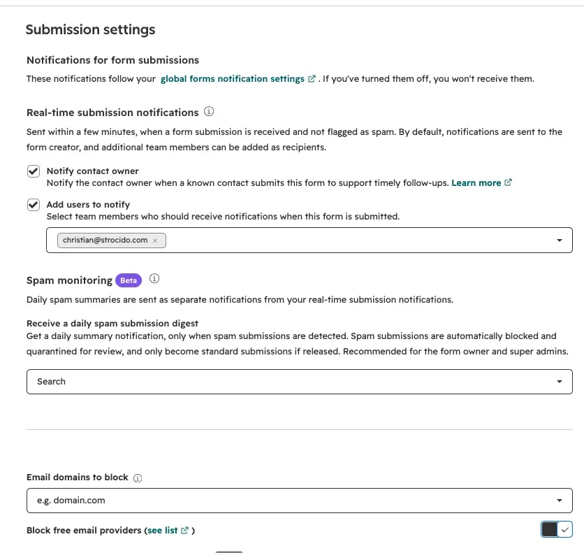 HubSpot form editor Submission settings tab with the Block free email providers switch turned on